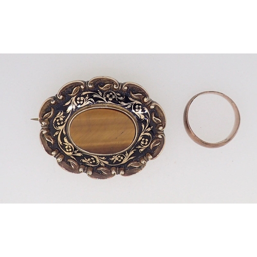 425 - A Victorian gold oval brooch set tigers eye with enamel surround 15.5g total weight (unmarked but te... 