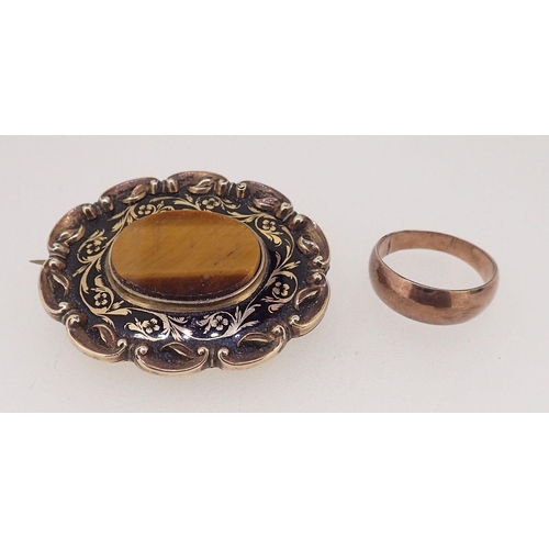 425 - A Victorian gold oval brooch set tigers eye with enamel surround 15.5g total weight (unmarked but te... 