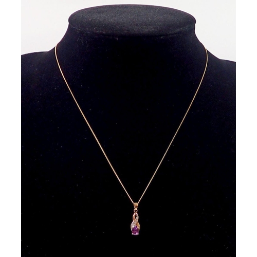 430 - A 9 carat gold amethyst pendant, 1.5cm diameter and chain, 40cm long