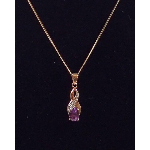 430 - A 9 carat gold amethyst pendant, 1.5cm diameter and chain, 40cm long