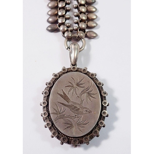 443 - A Victorian silver oval locket engraved bird on silver fancy link chain, unmarked, 71g