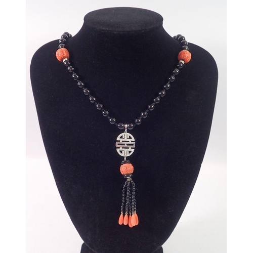 444 - An Art Deco style 15ct white gold onyx and coral bead necklace with diamond set geometric drop  and ... 