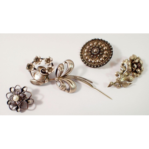 451 - A Swedish silver flower form brooch by Ge-Ka Smycken, a sterling silver circular brooch and two whit... 