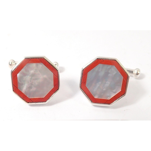 477 - A pair of silver, red stone and mother of pearl cufflinks