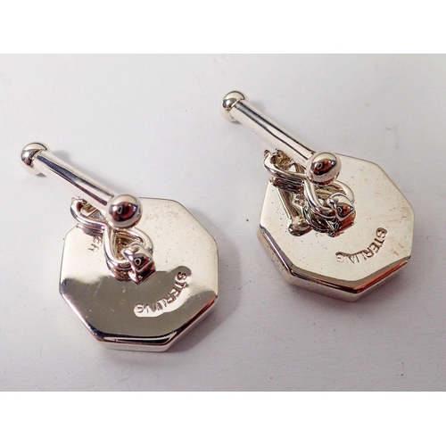 477 - A pair of silver, red stone and mother of pearl cufflinks