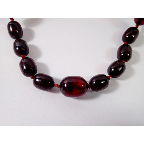 478 - A long cherry amber bead necklace, 105cm long