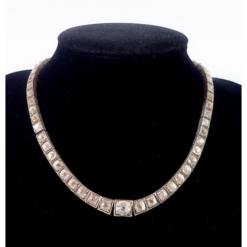 490 - A French Art Deco silver and paste necklace, the gold clasp marked with an eagle's head, the silver ... 