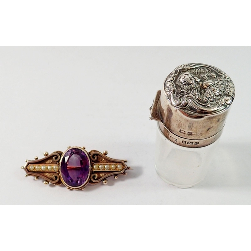 491 - A silver and amethyst brooch (not hallmarked) and a silver mounted smelling salts bottle