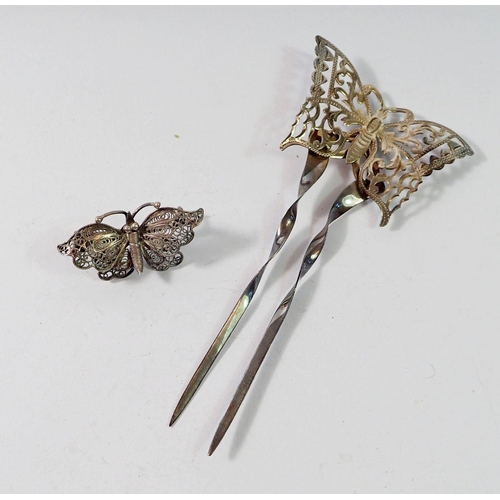 493 - A silver butterfly hair comb, 10.5cm and a white metal filigree brooch