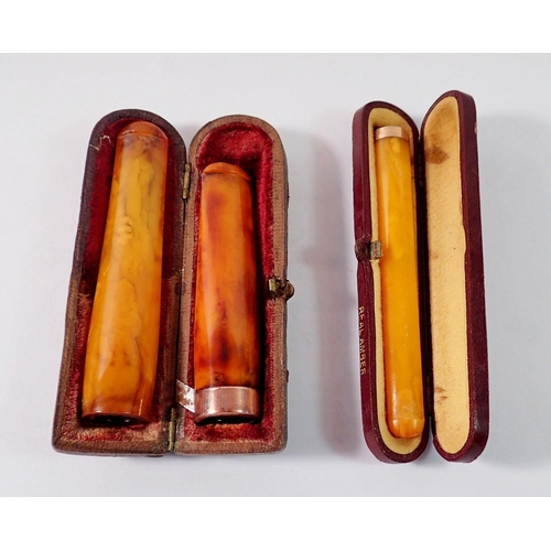 494 - A 9 carat gold mounted amber cheroot holder, a silver gilt one (800 standard) cased and an amber che... 