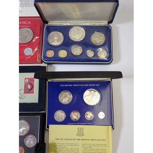 613 - A group of seven coin sets including 1973 & 1975 British Virgin Islands containing silver one dollar... 