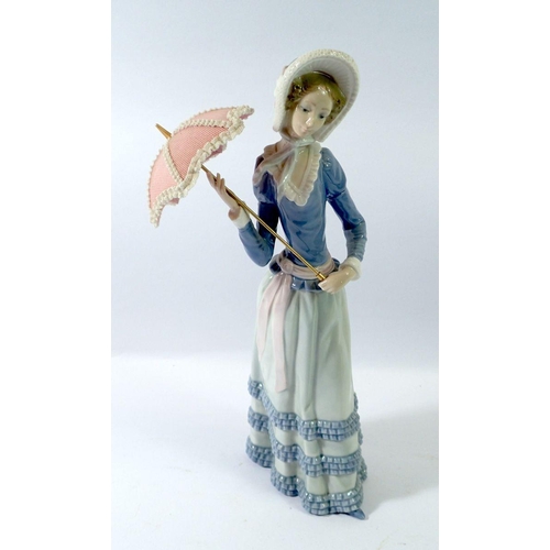 64 - A Lladro figure girl with umbrella