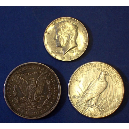 652 - A 1921 USA margan dollar, 1925 peace dollar and 1966 JFK half dollar, silver content, total weight 6... 