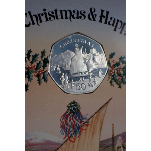 687 - Three Pobjoy Mint Isle of Man silver proof Christmas fifty pences, each mounted in Christmas card, 1... 