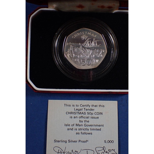 692 - Three Pobjoy Mint Isle of Man silver proof coins including 1980 Christmas fifty pence cased, 1982 Wo... 