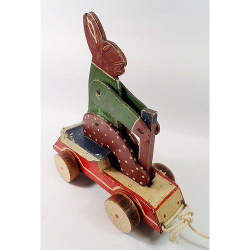 806 - An early 20th century wooden pull along rabbit toy, 30cm long