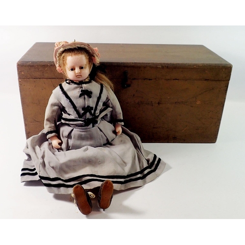 825 - A Victorian wax doll with cloth body, wax arms and legs, original clothing, hat, shoes bolster pillo... 