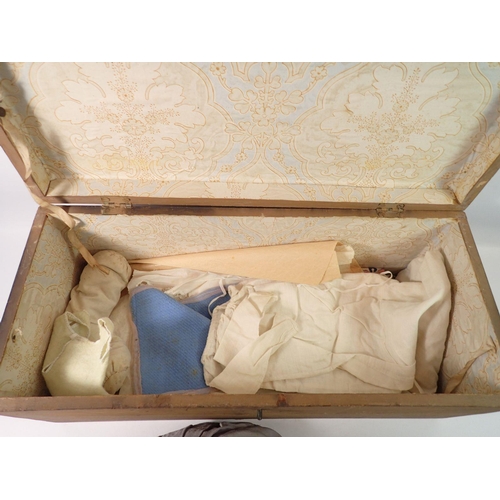 825 - A Victorian wax doll with cloth body, wax arms and legs, original clothing, hat, shoes bolster pillo... 