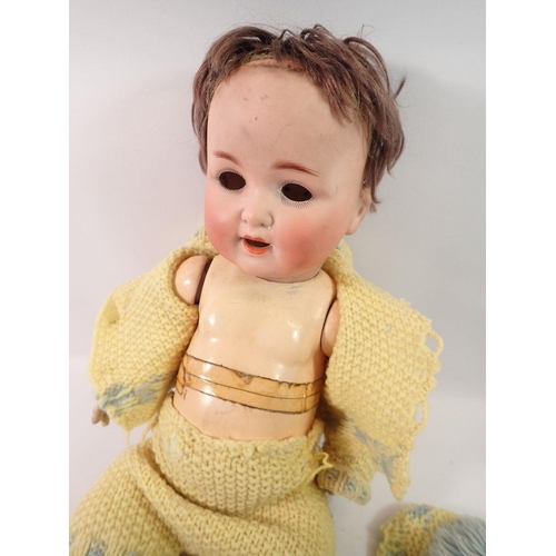 827 - A bisque headed composition doll with cry voice box - a/f, eyes loose, open mouth with teeth and red... 