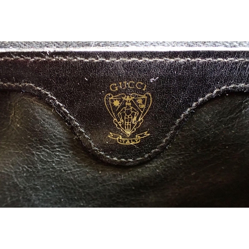 841 - A vintage 1960's Gucci black leather handbag with gilt metal clasp, shoulder strap and purse, 23.5 x... 