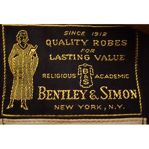 848 - Two Northern Robe makers graduation gowns together with a Bentley and Simon New York example