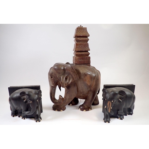 942 - An Indian carved wood elephant and temple table lamp and two ebony elephant bookends (lamp 34cm but ... 