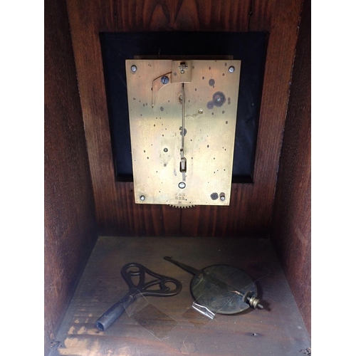 944 - A Victorian oak mantel clock with carved case and brass dial