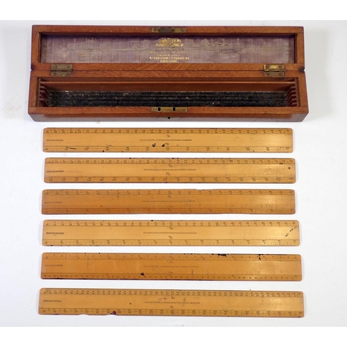 950 - A box of six wooden rulers by W Harling plus two Naval ebonies parallel rulers