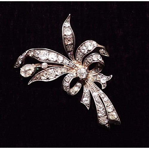 391 - An antique yellow and white gold spray brooch set diamonds to tied ribbons and leaves, 13g, 6cm x 3.... 