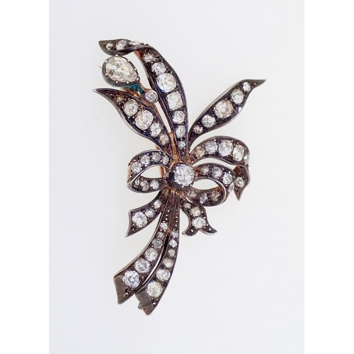 391 - An antique yellow and white gold spray brooch set diamonds to tied ribbons and leaves, 13g, 6cm x 3.... 