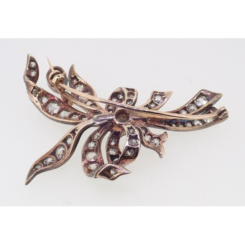 391 - An antique yellow and white gold spray brooch set diamonds to tied ribbons and leaves, 13g, 6cm x 3.... 