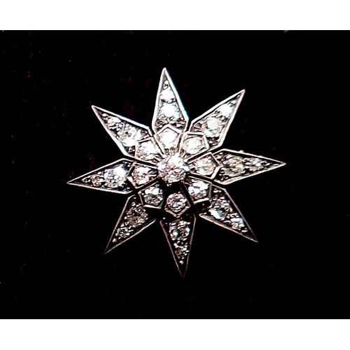 390 - A diamond set star form brooch 3.7cm diameter, 10g, unmarked but thought to be 18ct gold