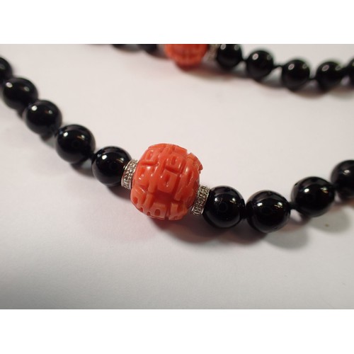 444 - An Art Deco style 15ct white gold onyx and coral bead necklace with diamond set geometric drop  and ... 