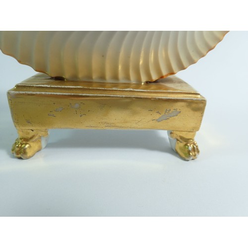 115 - A 19th century shell form gilt and cream inkwell, 13cm tall, 19cm wide