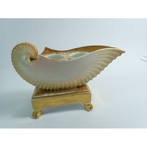 115 - A 19th century shell form gilt and cream inkwell, 13cm tall, 19cm wide