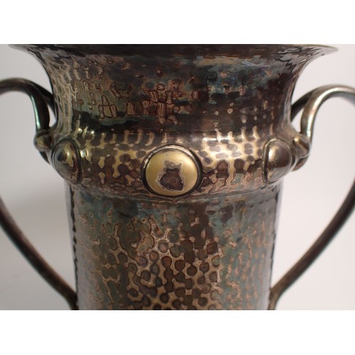 247 - A silver plated Arts & Crafts hammered bottle holder