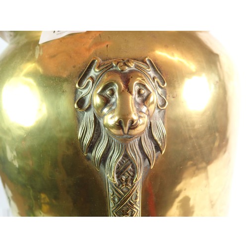 1291 - A brass jardiniere on tall lion mask and paw supports, 44cm