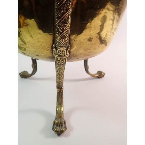 1291 - A brass jardiniere on tall lion mask and paw supports, 44cm