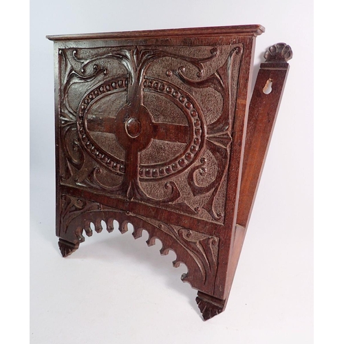 1002 - A carved oak wall magazine rack, 35 x 44cm