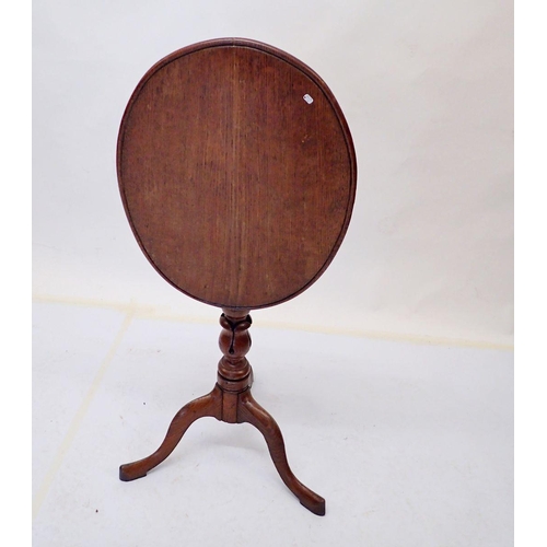 1005 - A 19th century oak oval tilt top wine table on carved and turned column with triple supports, 45 x 5... 