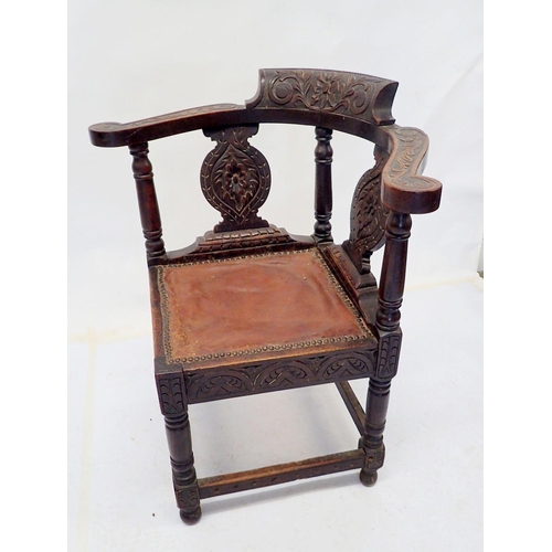 1017 - A Victorian elbow corner chair with all over carved decoration