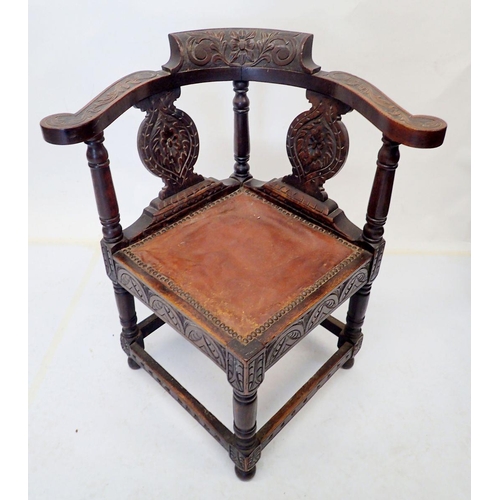 1017 - A Victorian elbow corner chair with all over carved decoration