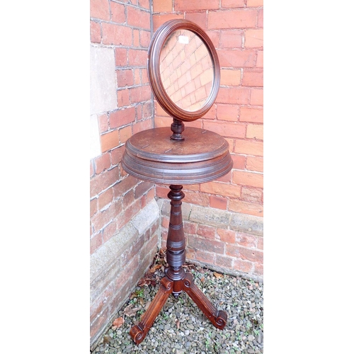 1029 - A Victorian mahogany circular shaving stand with circular mirror and two rise top compartments, all ... 