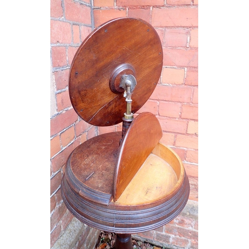 1029 - A Victorian mahogany circular shaving stand with circular mirror and two rise top compartments, all ... 