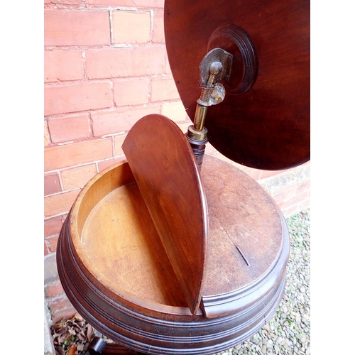 1029 - A Victorian mahogany circular shaving stand with circular mirror and two rise top compartments, all ... 