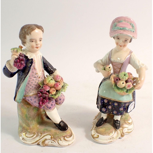 104 - A pair of Derby figures of boy and girl seated holding baskets of fruit, 12.5cm, unmarked