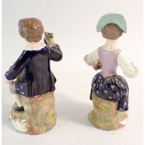 104 - A pair of Derby figures of boy and girl seated holding baskets of fruit, 12.5cm, unmarked