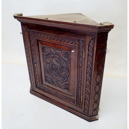 1046 - An 18th century oak single door corner cupboard with carved decoration, 78cm tall