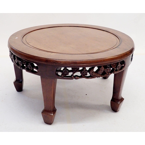 1057 - A Chinese carved circular coffee table with decorated frieze, 76cm diameter