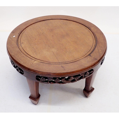 1057 - A Chinese carved circular coffee table with decorated frieze, 76cm diameter